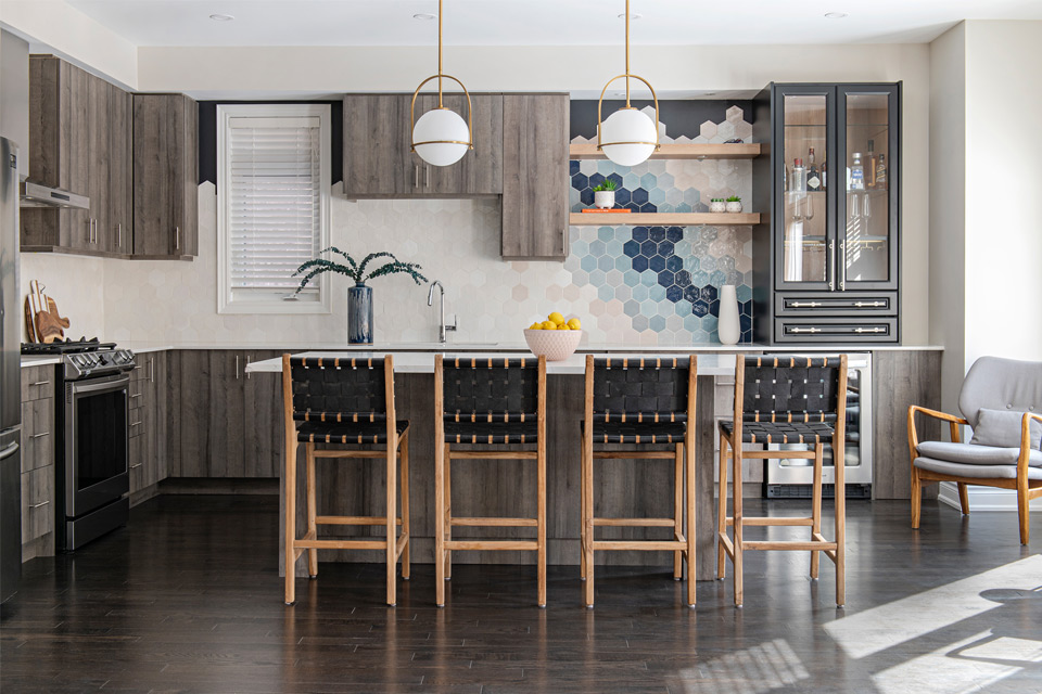 wood flooring in kitchen with colorful backsplash Design by Aman Than Interiors and Photography by Mike Chajecki